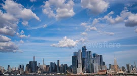 US: TIMELAPSE - Clouds move over Manhattan as sun sets in New York City
