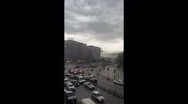 Motorcyclist almost hit by sheet of metal ripped off building by storm in Albania's capital