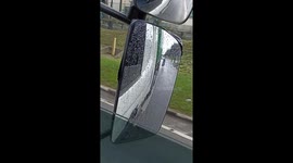 Cyclist hitching ride on truck flips over as vehicle drives through deep puddle