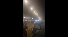Playful airbed joust duel at Creamfields Festival in England