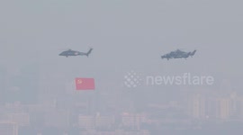 China: Flag-guarding echelon flies over military parade in Beijing in symbolic formation
