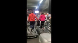 Adorable Couple Holds Hands at the Gym