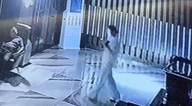 Woman, distracted by her phone, accidentally sits on security guard's lap