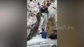 Onlooker rescues child trapped between waterfall rocks in China