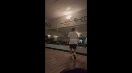 Staff disrupts gym goer's workout by diving across exercise balls in hilarious fashion