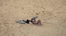 UK Weather Whimsy: Sun, Showers & a Stoic Bather!, brolly and beachwear. Cornwall, UK