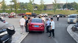 Students lift car blocking the road in China