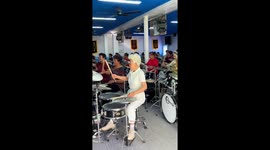 Rolling bones! Pensioners learn to play the drums at rock classes in China