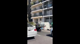 Motorcyclist balances flat-screen TV on his back in Buenos Aires, Argentina