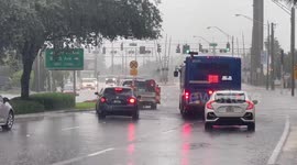 US: Cars Drive Through Street Flooding in Hollywood, FL