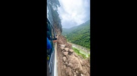 Bus navigates extreme narrow cliff road after landslide