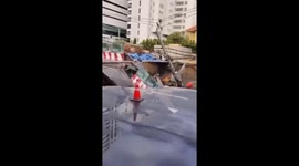 Truck teeters on edge of giant sinkhole that swallows road in Bangkok