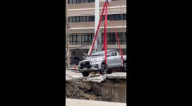 Police pickup truck lifted out of Bangkok sinkhole