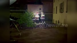 Italy: Families Rescued As Firefighters Push Flooded Car In Northern Lombardy