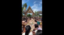 Ravenous festivalgoers swarm across tables as free buffet opens