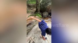 Student slips on rock while walking down waterfall