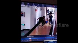 Comedic scene as firefighters slip one after another on freshly mopped floor during emergency call