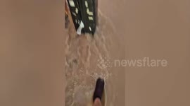 Tourists wade through floods to catch flight amid heavy rains in Ibiza