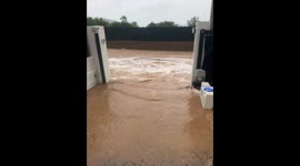 Rising floodwaters in streets threaten vehicles and homes in Ibiza, Spain