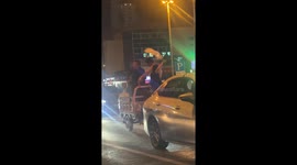Three men joyfully dance on a moving tricycle in Hebei, China
