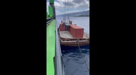 Car whacks into shipping container while being offloaded from vessel