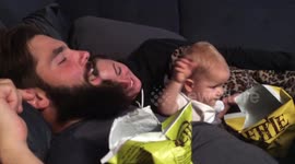 Role reversal: Baby feeds her daddy and uncle