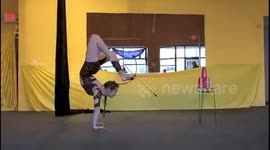 Newsflare Edit - Contortionist fires bow-and-arrow while doing a handstand
