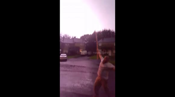 Man strikes lighting as it strikes (PERFECT TIMING)