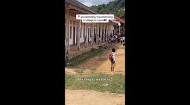 Bizarre moment village children scream and flee after seeing white tourist in Laos