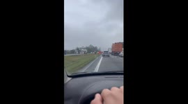 Truck Loaded With Wood Overturns on Road and Spills Cargo on Median