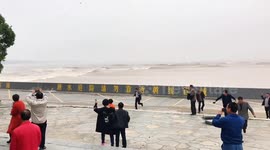 High tide waves splashing over Qiantang River embankment in Zhejiang, China