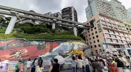Tourists gather to watch trains entering a building at liziba station in chongqing, china