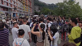 Tourists gather to watch trains entering a building at liziba station in chongqing, china