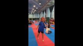 Woman tests helmet durability with fexible side kick in Guangdong, China