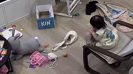 Toddler tumbles from chair after playing with cushion