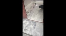 Painter plastering wall covered in white powder in Yunnan, China