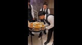 Server Carries Several Piles Of Plates