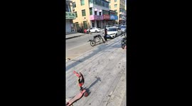 Man rides bicycle in unusual vertical position in Liaoning, China