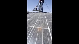 cleaning a solar panel with firework splatter
