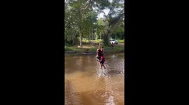 Children enjoy rope swing fun by the river in Mossoró, Brazil
