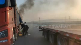 Truck catches fire on highway in Xinjiang, China