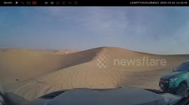 Vehicle performs desert ramp jump in Xinjiang, China