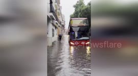 Red Tourist Bus Battles Torrents As Seville Streets Flood