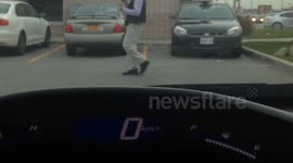 man dancing outside of gas station in Toronto