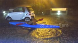 Man canoes on the flooded streets of Ischia, Italy