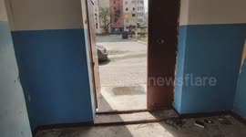 Filming the exterior of a burned residential building in Irpen, Kyiv region, Ukraine, on 23.04.2022. All floors are completely fire-damaged. A car in the yard shows damage from Russian shelling.
