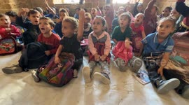 Palestinian students receive educational lessons inside a historic school in eastern Gaza City