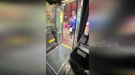 Locals board bus on flooded street amid rain in New York