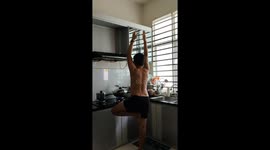 Man Turns Kitchen Time into Yoga Time While Cooking