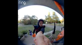 trick or treater runs from door after decoration tells him to.